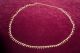Bauchkette aus goldfarbenem Metall mit Glöckchen
